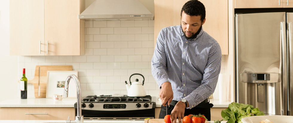 An image of a person performing an ordinary task in a kitchen